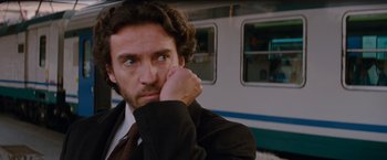 Movie still from “The Tourist” (2010), directed by Florian Henckel von Donnersmarck – A person wearing a suit and tie; Close Up shot, Low angle