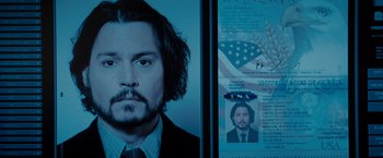 Movie still from “The Tourist” (2010), directed by Florian Henckel von Donnersmarck – A man's face and a picture of himself; Close Up shot, Low angle