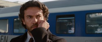 Movie still from “The Tourist” (2010), directed by Florian Henckel von Donnersmarck – A person leaning on a train window; Close Up shot, Low angle