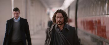 Movie still from “The Tourist” (2010), directed by Florian Henckel von Donnersmarck – A person wearing a coat; Medium shot, Over the shoulder angle