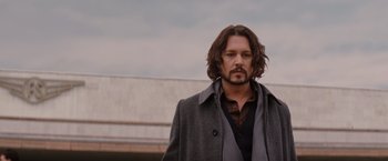 Movie still from “The Tourist” (2010), directed by Florian Henckel von Donnersmarck – A person with long hair wearing a coat; Close Up shot, Low angle