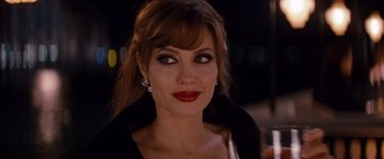 Movie still from “The Tourist” (2010), directed by Florian Henckel von Donnersmarck – A person wearing a dress; Close Up shot, Over the shoulder angle