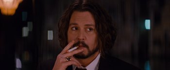 Movie still from “The Tourist” (2010), directed by Florian Henckel von Donnersmarck – A person smoking a cigarette; Close Up shot, Low angle