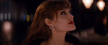Movie still from “The Tourist” (2010), directed by Florian Henckel von Donnersmarck – A person wearing a earring; Close Up shot, Over the shoulder angle
