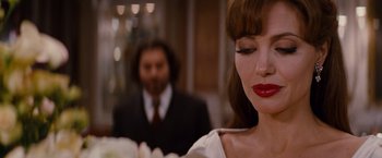 Movie still from “The Tourist” (2010), directed by Florian Henckel von Donnersmarck – A person wearing a suit and tie; Close Up shot, Over the shoulder angle