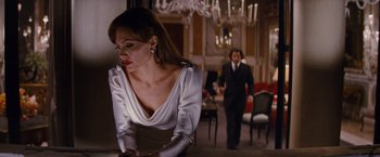 Movie still from “The Tourist” (2010), directed by Florian Henckel von Donnersmarck – A man and a woman in a room with chandeliers; Medium shot, Over the shoulder angle