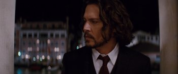 Movie still from “The Tourist” (2010), directed by Florian Henckel von Donnersmarck – A person wearing a suit and tie; Close Up shot, Low angle