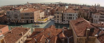 Movie still from “The Tourist” (2010), directed by Florian Henckel von Donnersmarck – An aerial view of a city with a canal and buildings; Extreme Wide shot, High angle