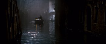 Movie still from “The Tourist” (2010), directed by Florian Henckel von Donnersmarck – A man is in a boat in the water at night; Extreme Wide shot, High angle