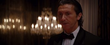 Movie still from “The Tourist” (2010), directed by Florian Henckel von Donnersmarck – A person wearing a suit and bow tie; Close Up shot, Low angle