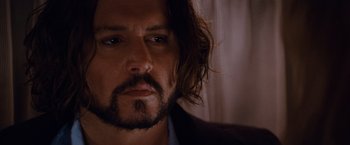 Movie still from “The Tourist” (2010), directed by Florian Henckel von Donnersmarck – A person with long hair and a beard; Close Up shot, Over the shoulder angle