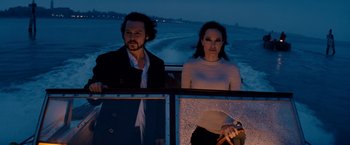 Movie still from “The Tourist” (2010), directed by Florian Henckel von Donnersmarck – A man and a woman are sitting in a boat at night; Medium shot, Low angle