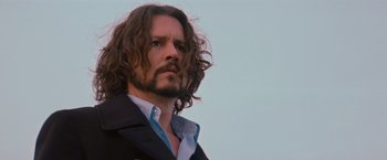 Movie still from “The Tourist” (2010), directed by Florian Henckel von Donnersmarck – A person with long hair; Close Up shot, Low angle