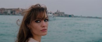 Movie still from “The Tourist” (2010), directed by Florian Henckel von Donnersmarck – A person near a body of water; Close Up shot, Over the shoulder angle