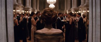 Movie still from “The Tourist” (2010), directed by Florian Henckel von Donnersmarck – A group of people standing in a room; Medium shot, Over the shoulder angle