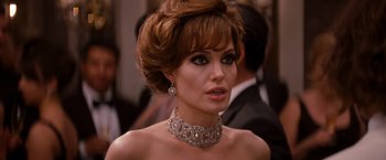 Movie still from “The Tourist” (2010), directed by Florian Henckel von Donnersmarck – A person wearing a necklace and earrings; Close Up shot, Over the shoulder angle