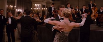 Movie still from “The Tourist” (2010), directed by Florian Henckel von Donnersmarck – A man and a woman dancing in front of an orchestra; Medium shot, Over the shoulder angle