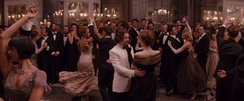 Movie still from “The Tourist” (2010), directed by Florian Henckel von Donnersmarck – A group of people in formal wear dancing together; Wide shot, Over the shoulder angle