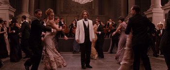 Movie still from “The Tourist” (2010), directed by Florian Henckel von Donnersmarck – A group of people in formal wear dancing in front of a crowd; Wide shot, Over the shoulder angle