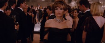 Movie still from “The Tourist” (2010), directed by Florian Henckel von Donnersmarck – A woman wearing a black dress and a diamond necklace; Medium shot, Over the shoulder angle