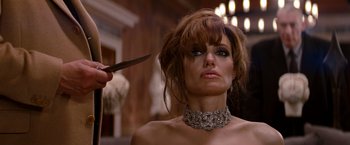 Movie still from “The Tourist” (2010), directed by Florian Henckel von Donnersmarck – A woman is cutting her hair while wearing a necklace; Close Up shot, Over the shoulder angle