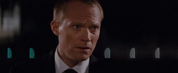 Movie still from “The Tourist” (2010), directed by Florian Henckel von Donnersmarck – A person wearing a suit and tie; Close Up shot, Over the shoulder angle