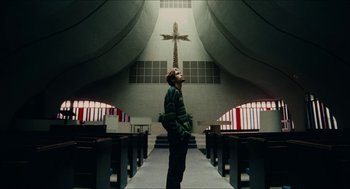Movie still from “Euphoria” (2019), created by Sam Levinson – A man standing in a church looking up at a cross; Wide shot, Low angle