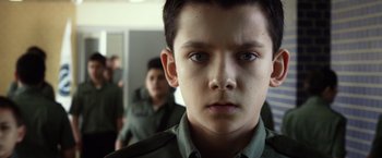 Movie still from “Ender's Game” (2013), directed by Gavin Hood – A young boy is looking into the camera; Close Up shot, Low angle