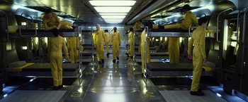 Movie still from “Ender's Game” (2013), directed by Gavin Hood – A group of men in yellow suits standing in a room; Wide shot, High angle