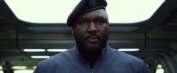 Movie still from “Ender's Game” (2013), directed by Gavin Hood – A man wearing a blue jacket and wearing a hat; Close Up shot, Low angle