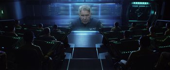 Movie still from “Ender's Game” (2013), directed by Gavin Hood – A man sitting in front of a computer screen; Medium shot, Over the shoulder angle