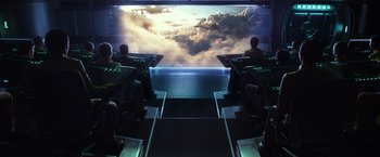 Movie still from “Ender's Game” (2013), directed by Gavin Hood – A group of people sitting in front of a large screen; Extreme Wide shot, High angle
