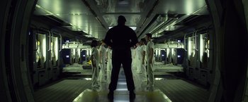 Movie still from “Ender's Game” (2013), directed by Gavin Hood – A group of men in white uniforms standing in a room; Wide shot, Low angle