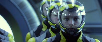 Movie still from “Ender's Game” (2013), directed by Gavin Hood – A group of people in yellow and black space suits; Close Up shot, Low angle