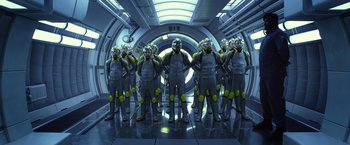 Movie still from “Ender's Game” (2013), directed by Gavin Hood – A group of people standing next to each other in a room; Wide shot, Low angle