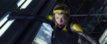 Movie still from “Ender's Game” (2013), directed by Gavin Hood – A person in a yellow and black suit and helmet; Medium shot, Low angle