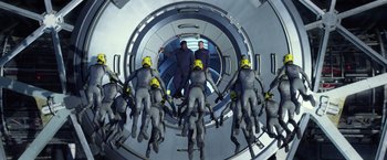 Movie still from “Ender's Game” (2013), directed by Gavin Hood – A group of people in grey suits and yellow helmets; Wide shot, Overhead angle