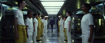 Movie still from “Ender's Game” (2013), directed by Gavin Hood – A group of men in white suits standing in a hallway; Wide shot, Low angle