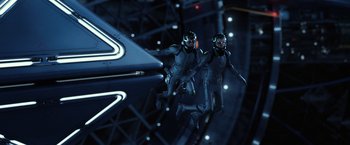 Movie still from “Ender's Game” (2013), directed by Gavin Hood – Two men in blue suits are jumping in the air; Wide shot, Overhead angle