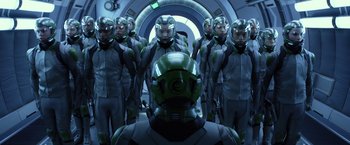 Movie still from “Ender's Game” (2013), directed by Gavin Hood – A group of people in a room with a man in a helmet; Medium shot, High angle