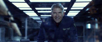 Movie still from “Ender's Game” (2013), directed by Gavin Hood – A man in a blue jacket smiling for the camera; Close Up shot, Low angle