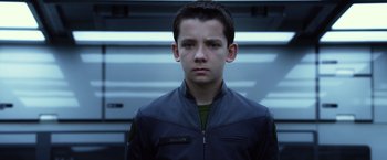 Movie still from “Ender's Game” (2013), directed by Gavin Hood – A young man in a jacket looking at the camera; Close Up shot, Low angle