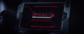 Movie still from “Ender's Game” (2013), directed by Gavin Hood – A digital alarm clock showing the time 3 : 0 1 pm; Extreme Close Up shot, High angle
