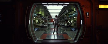 Movie still from “Ender's Game” (2013), directed by Gavin Hood – A man standing in a room with a bunch of people; Wide shot, Low angle