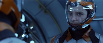 Movie still from “Ender's Game” (2013), directed by Gavin Hood – A man with a helmet is looking at the camera; Close Up shot, Over the shoulder angle
