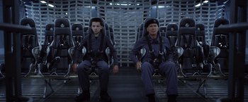 Movie still from “Ender's Game” (2013), directed by Gavin Hood – Two people sitting in chairs in a room; Medium shot, Overhead angle