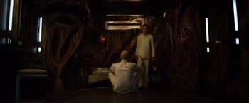 Movie still from “Ender's Game” (2013), directed by Gavin Hood – Two men in white shirts are in a room with a dragon; Wide shot, High angle