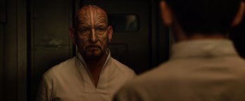 Movie still from “Ender's Game” (2013), directed by Gavin Hood – A man with a tattoo on his face looking at himself in the mirror; Close Up shot, Over the shoulder angle