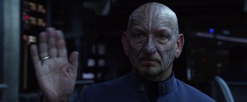 Movie still from “Ender's Game” (2013), directed by Gavin Hood – A man with a face tattoo is looking at the camera; Close Up shot, Over the shoulder angle