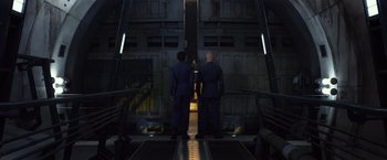 Movie still from “Ender's Game” (2013), directed by Gavin Hood – Two men standing in front of an open door; Wide shot, Low angle